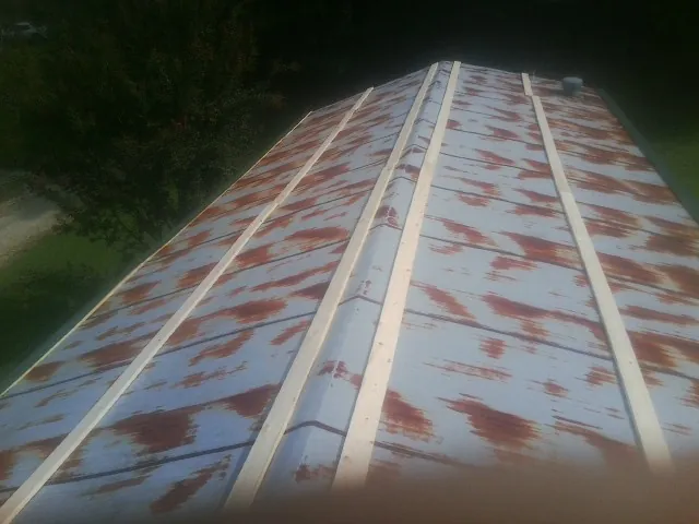 Rusted metal roof panels with new wood purlins before replacement — Storm Damage Roof Repair in Signal Mountain by Roofing Brothers