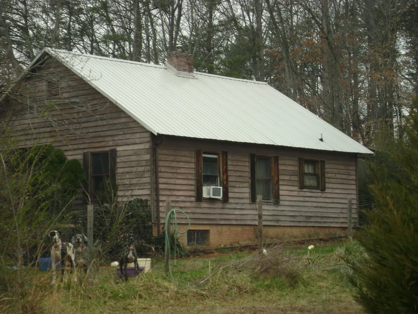 White metal roof on an old wood sided farmhouse, from a Asphalt Shingle Roof Repair job in Signal Mountain